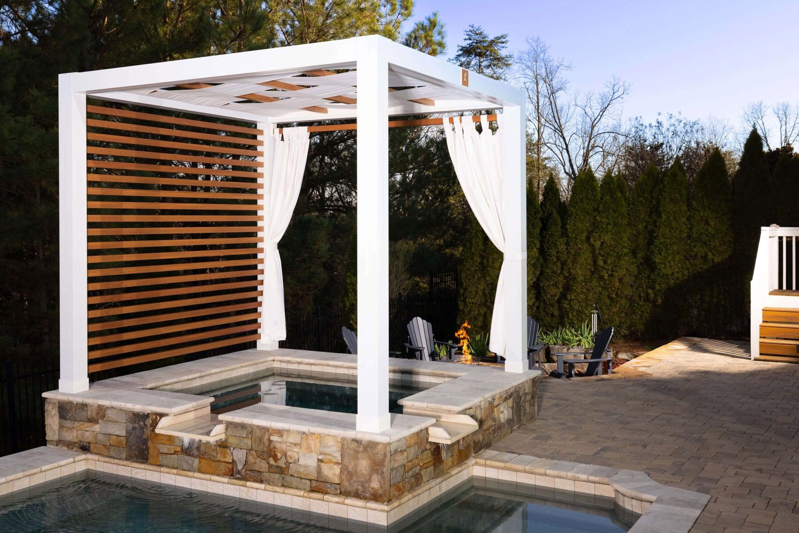 White Cabana X over a backyard spa with privacy slats and curtains
