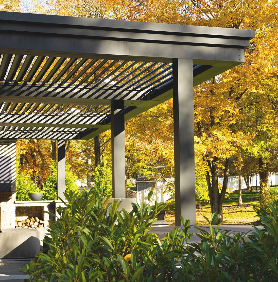 Modern Cabana X with louvered roof surrounded by autumn trees