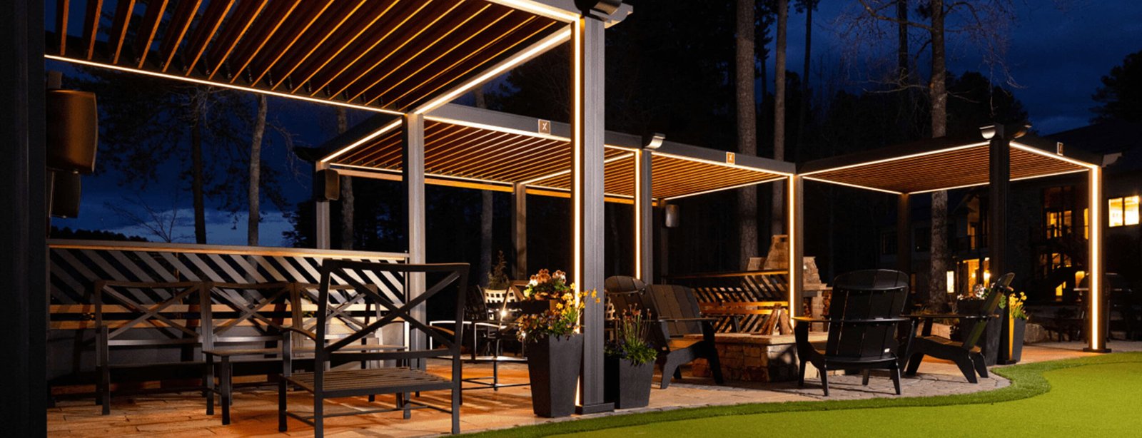 Illuminated Cabana X structures creating an outdoor lounge at night
